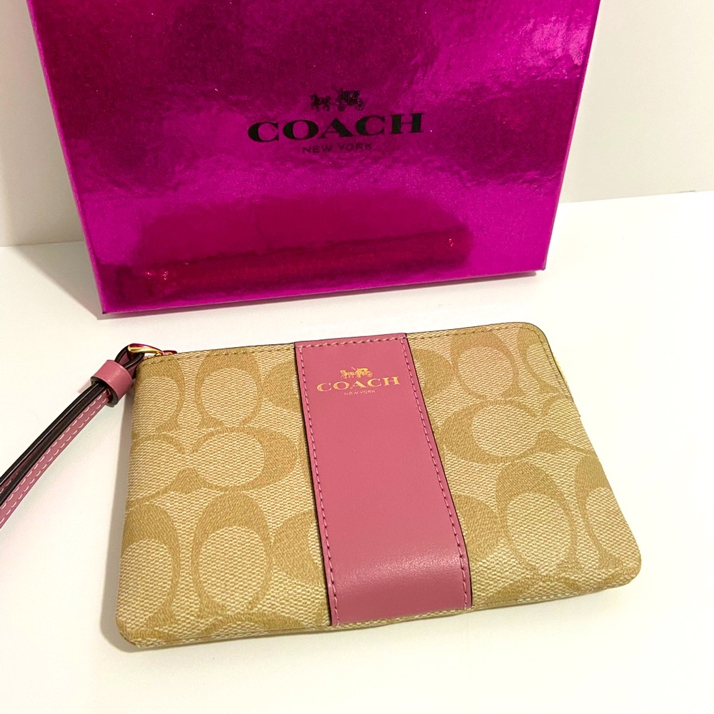 COACH WRISTLET WITH C-SIGNATURE COACH ON IT AND WITH A PINK STRIPE ON FRONT. - Picture 1 of 8